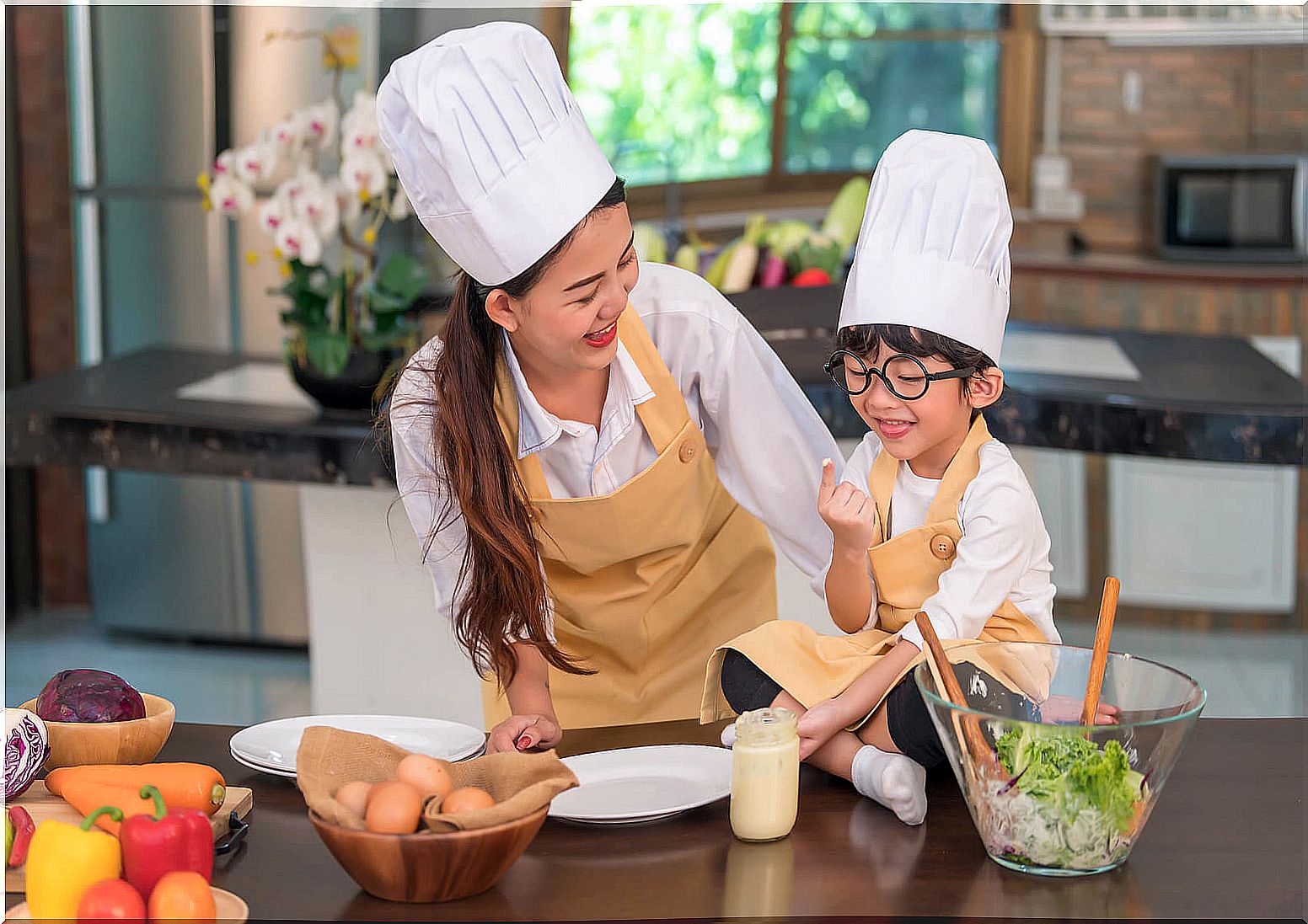 Mother and son cooking together to foster children's intelligence.