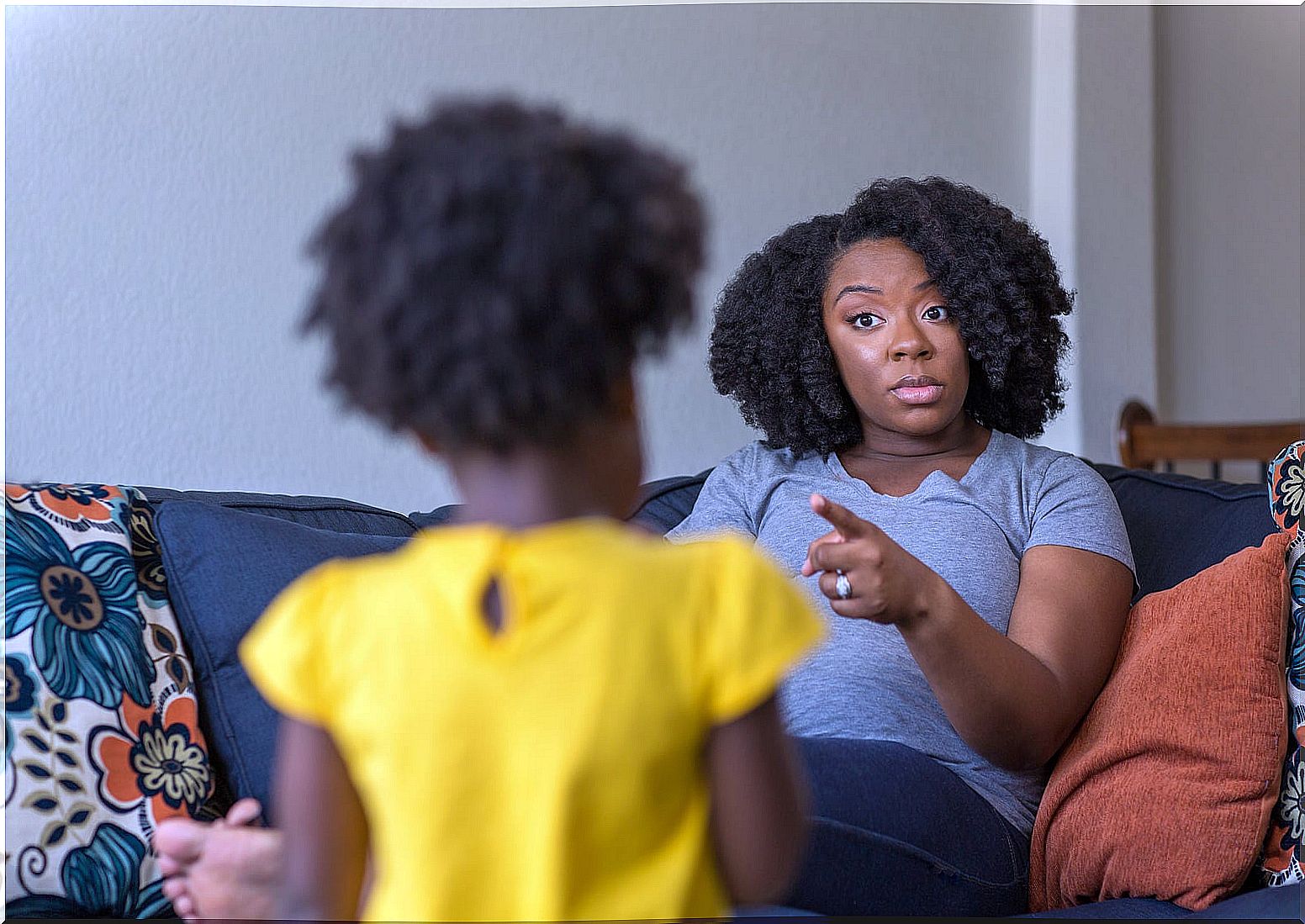 Mother scolding her daughter with discipline problems.