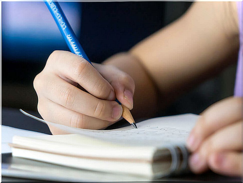 Girl writing a gratitude journal.