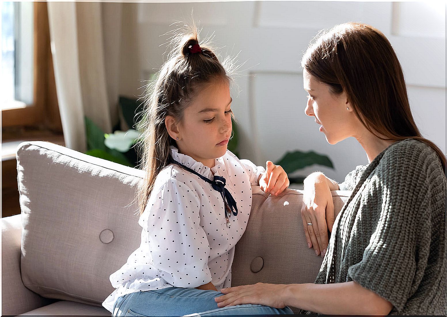 Mother talking to her daughter about assertive communication.