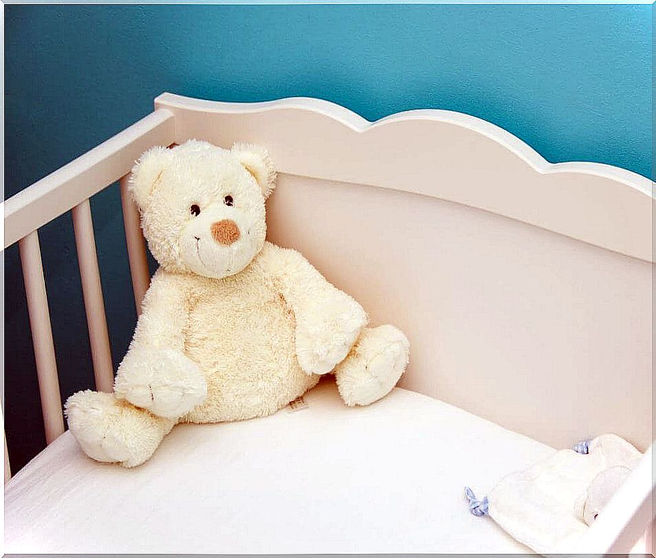 Teddy bear in a crib