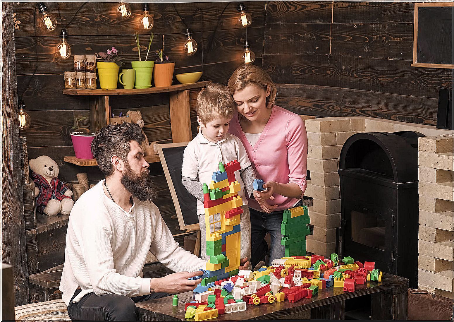 Parents playing with their child with the LEGO Education building pieces.