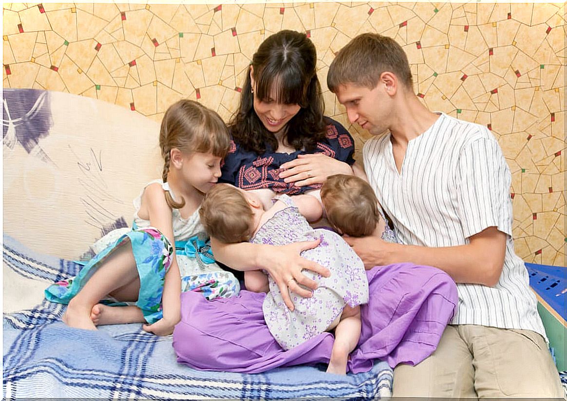 Breastfeeding of two children at the same time.