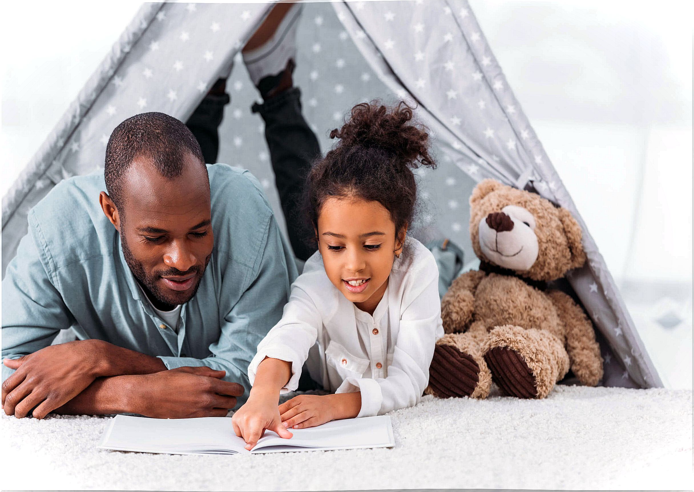 Father with his daughter reading a story.