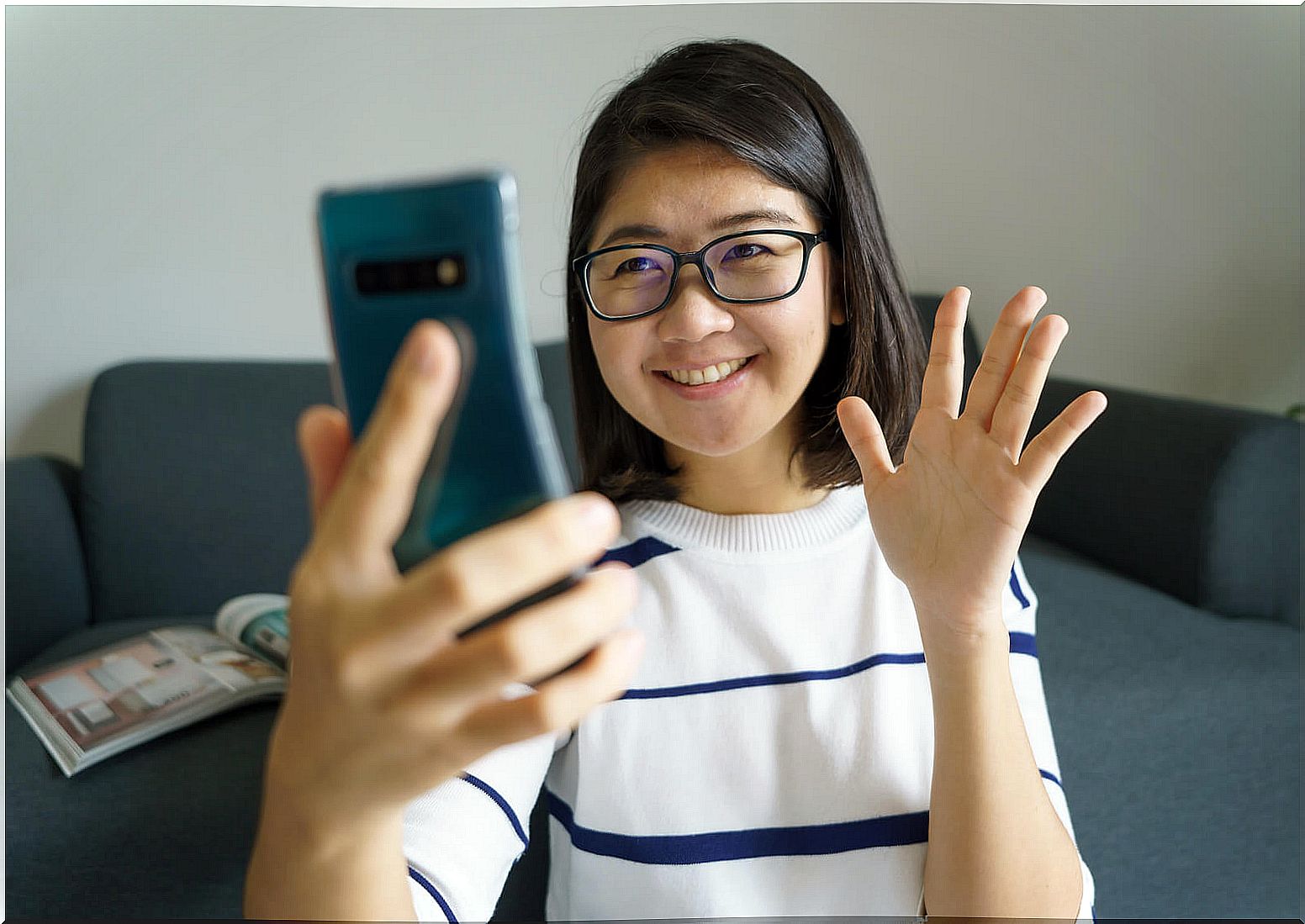 Young girl making video call during quarantine to maintain social distance.