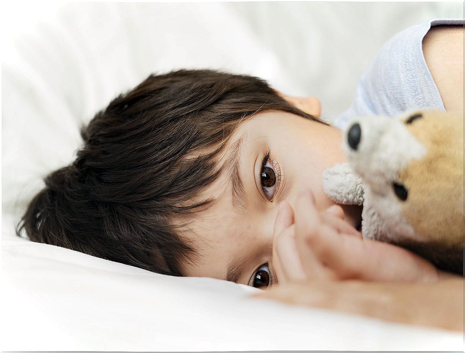 With hugging her teddy bear because she can't sleep well.