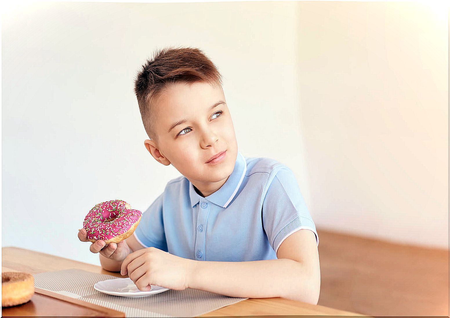 Child eating a donut.