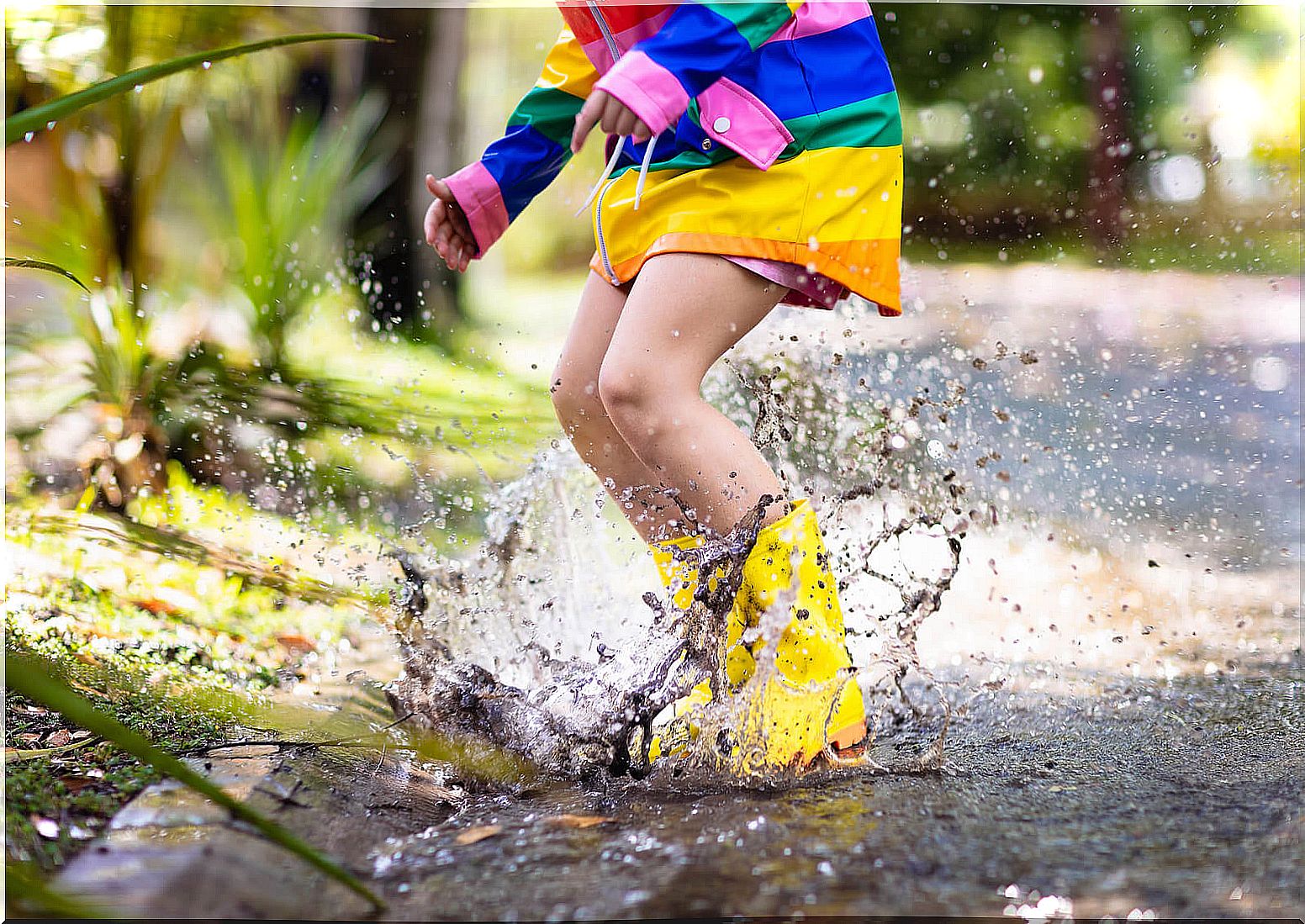 Girl jumping in puddles because she knows that the balance between order and creativity is very important.