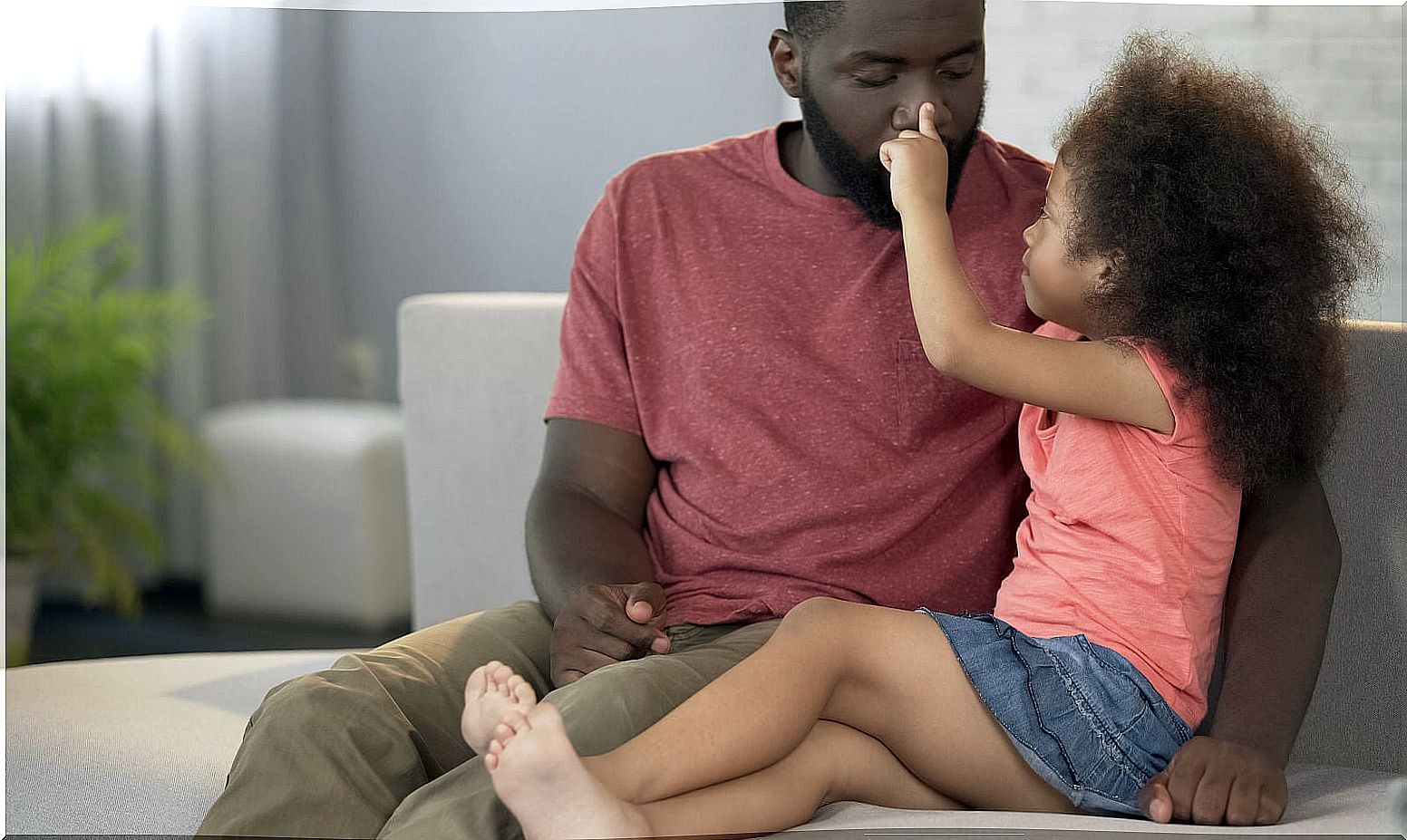 Father playing with his daughter with great affection.