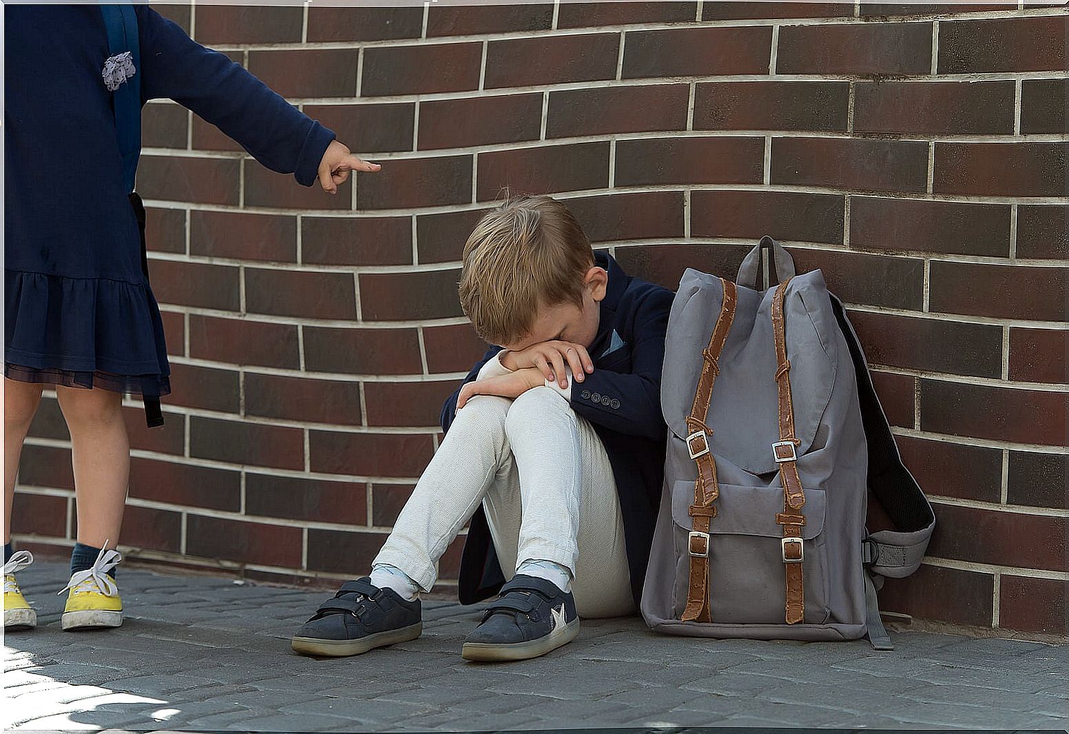 Child suffering bullying at school.