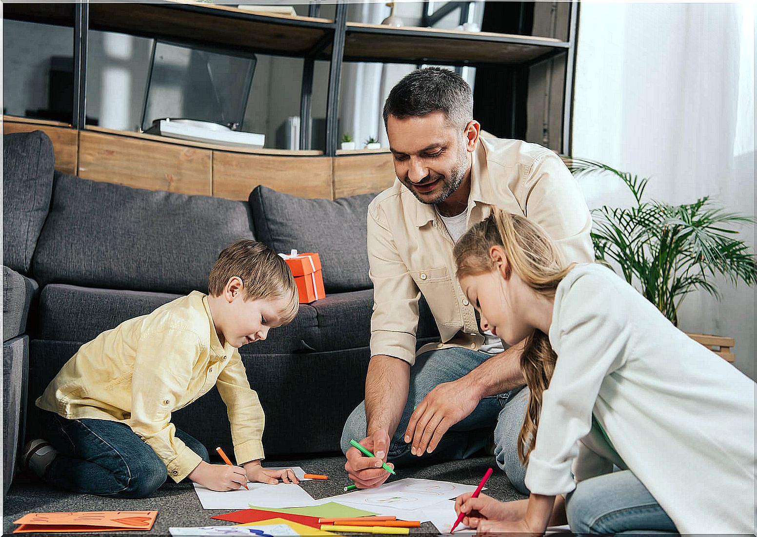 Attentive father painting with his children.