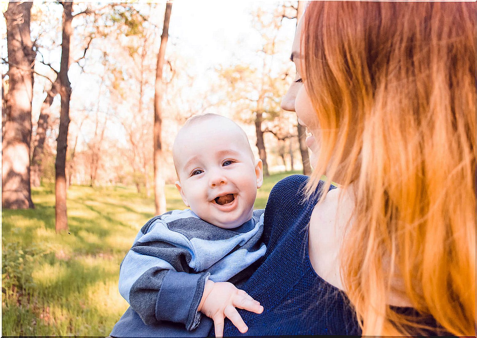 Mother with her baby in her arms being a safe space for him.