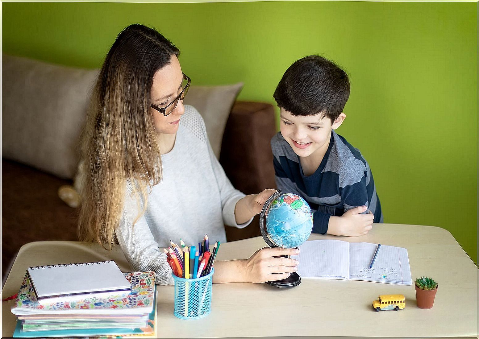 Mother and son practicing homeschooling.