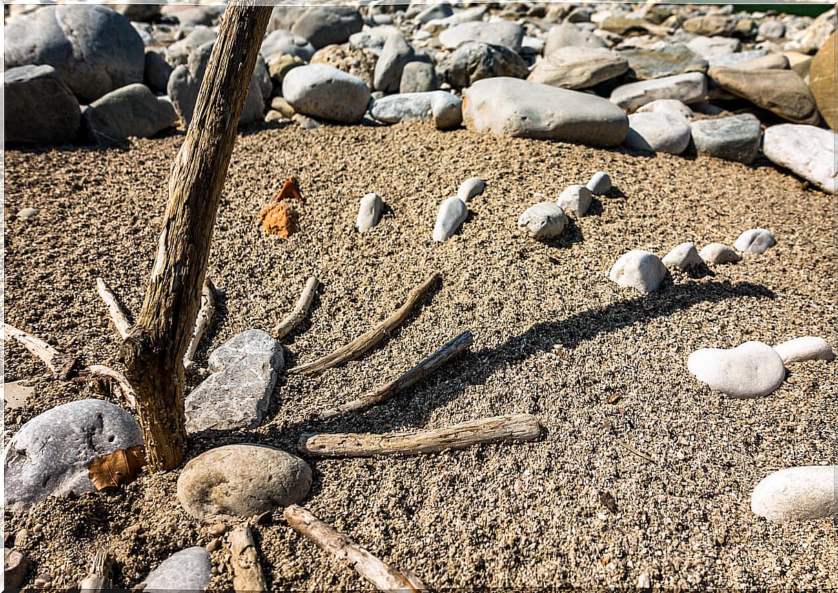 Homemade sundial on the beach.