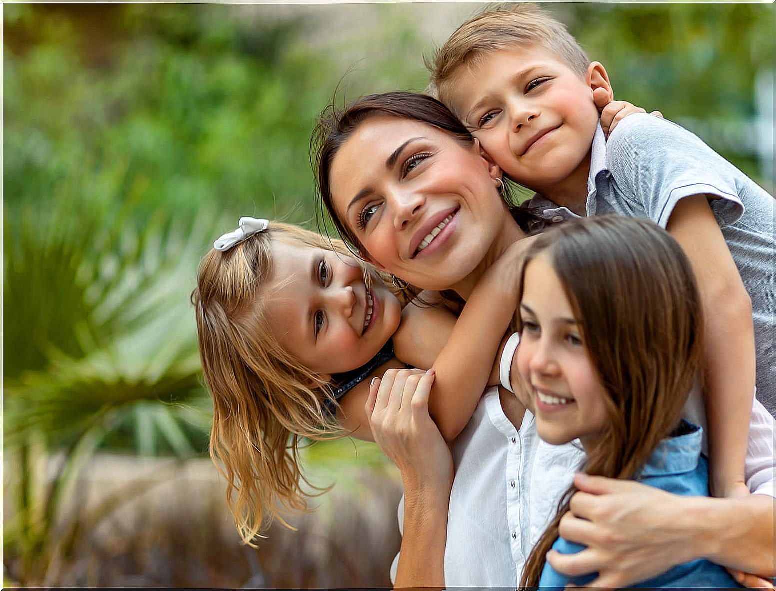 Happy mother feeling the warmth of her children within the chaos of motherhood.