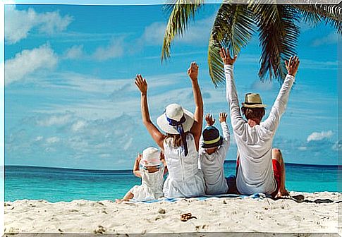 Parents with their children on the beach enjoying the holidays.