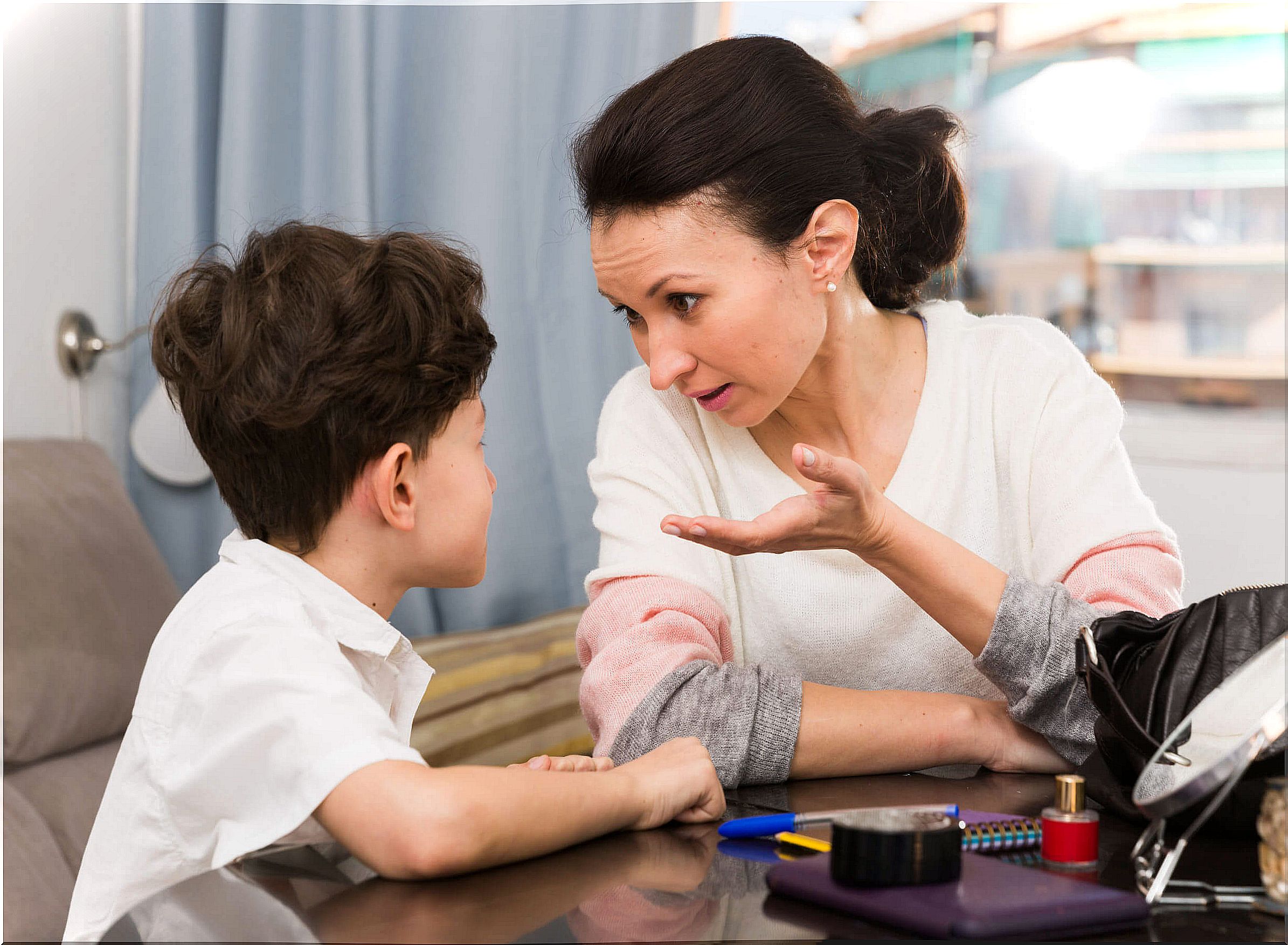 Mother talking to her son to teach him when to stop talking.