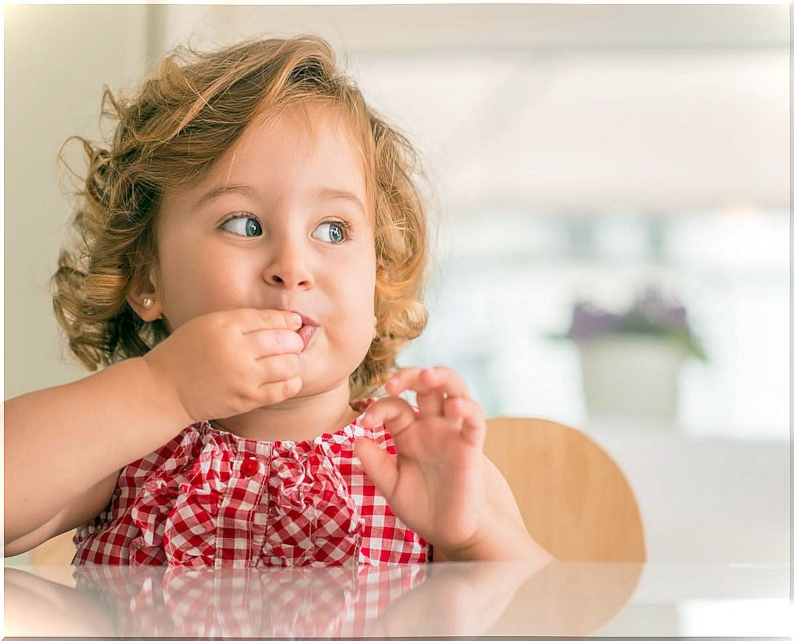 Little girl doing the fruit snack challenge.