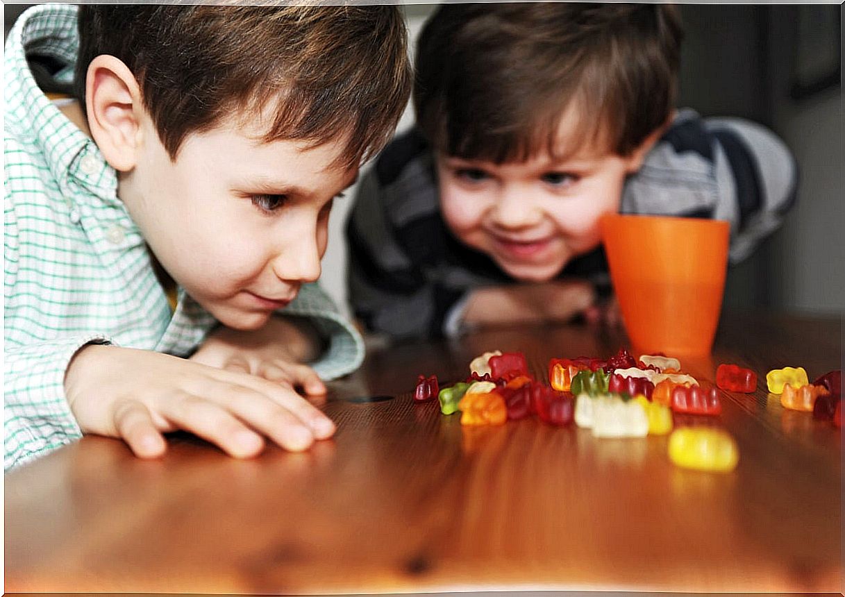 Children doing the fruit snack challenge with sweets.