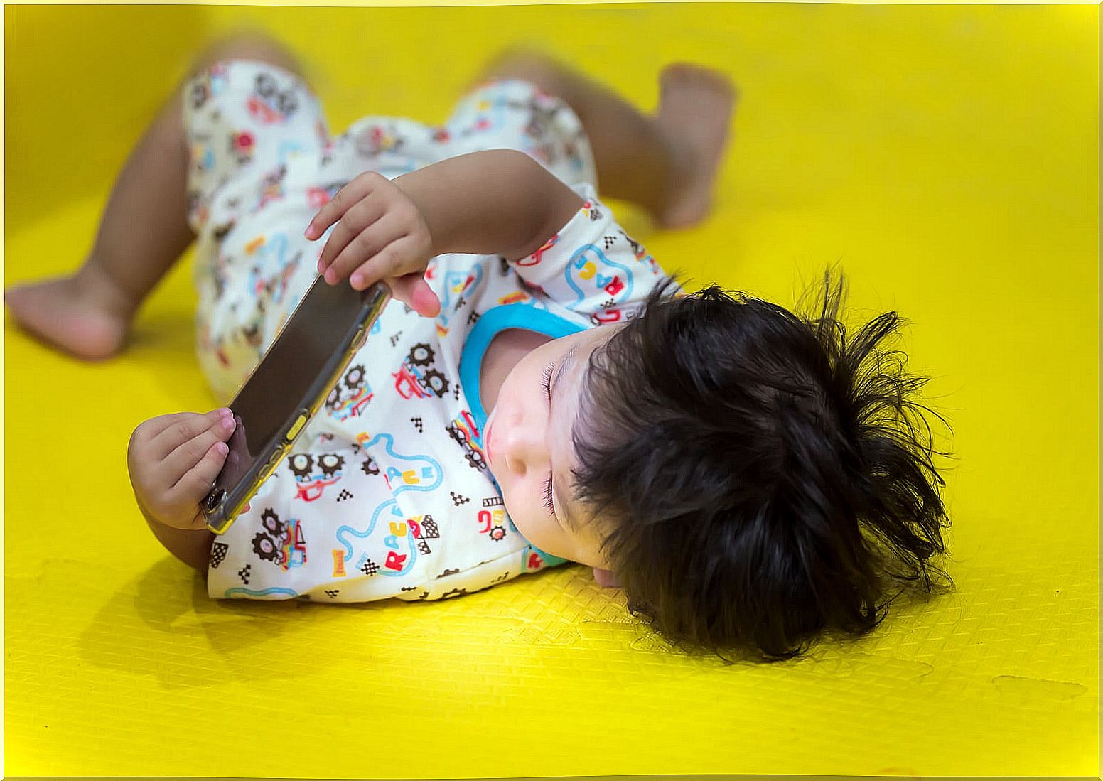 Child playing with a mobile.