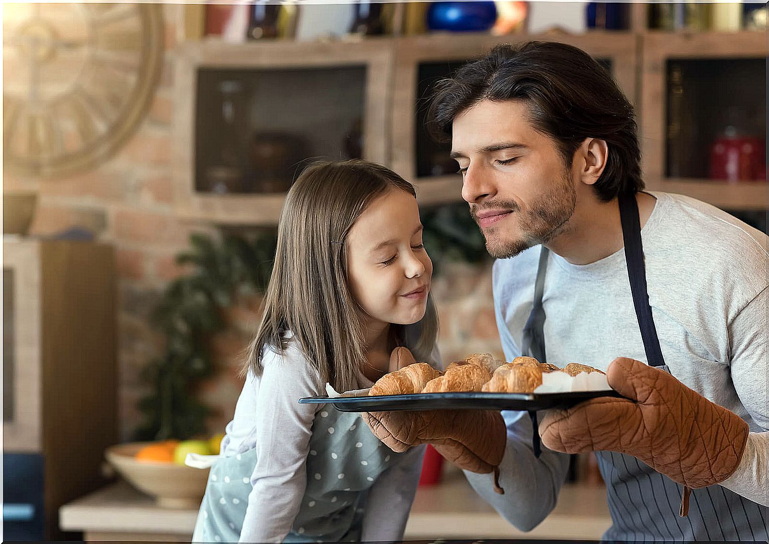 Father and daughter making baked croissants to fill their memories with smell.