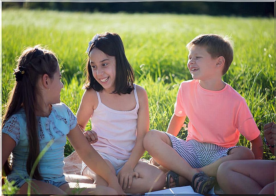 Children in the field playing the game of the dragon and the turtle