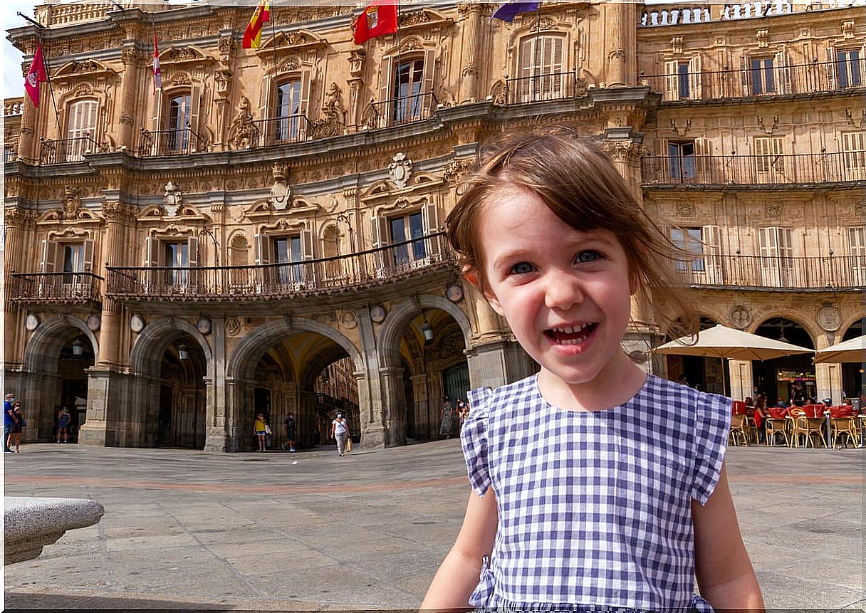 Happy girl in the main square of Salamanca.