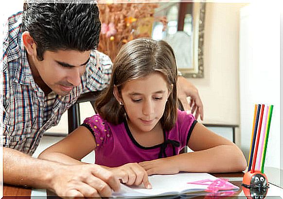 Dad helping his daughter do homework