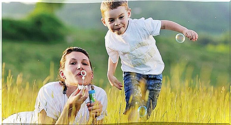 Mother and son in the field blowing bubbles